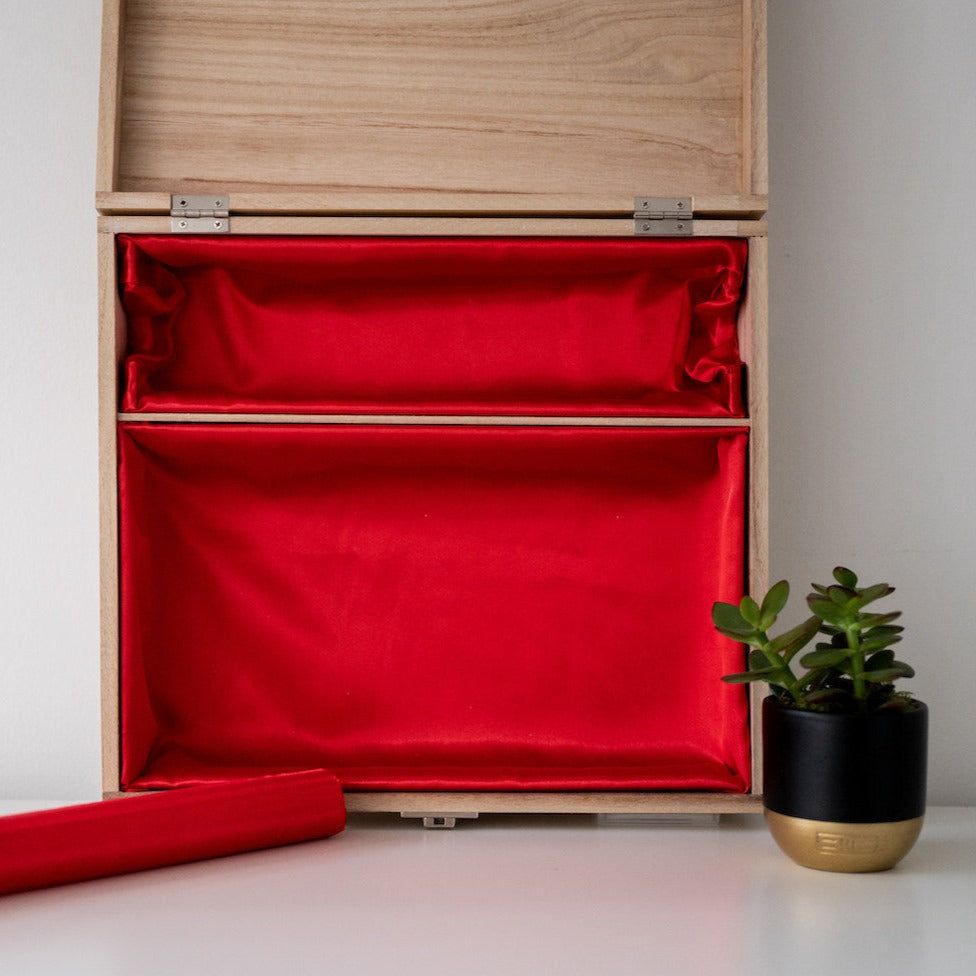 Open wooden box with red lining and removable bangle bar