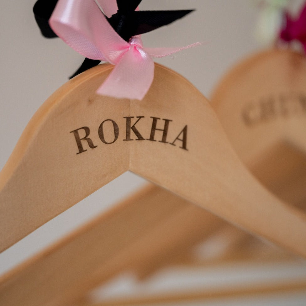 Personalised wooden hangers with pink and black bow 