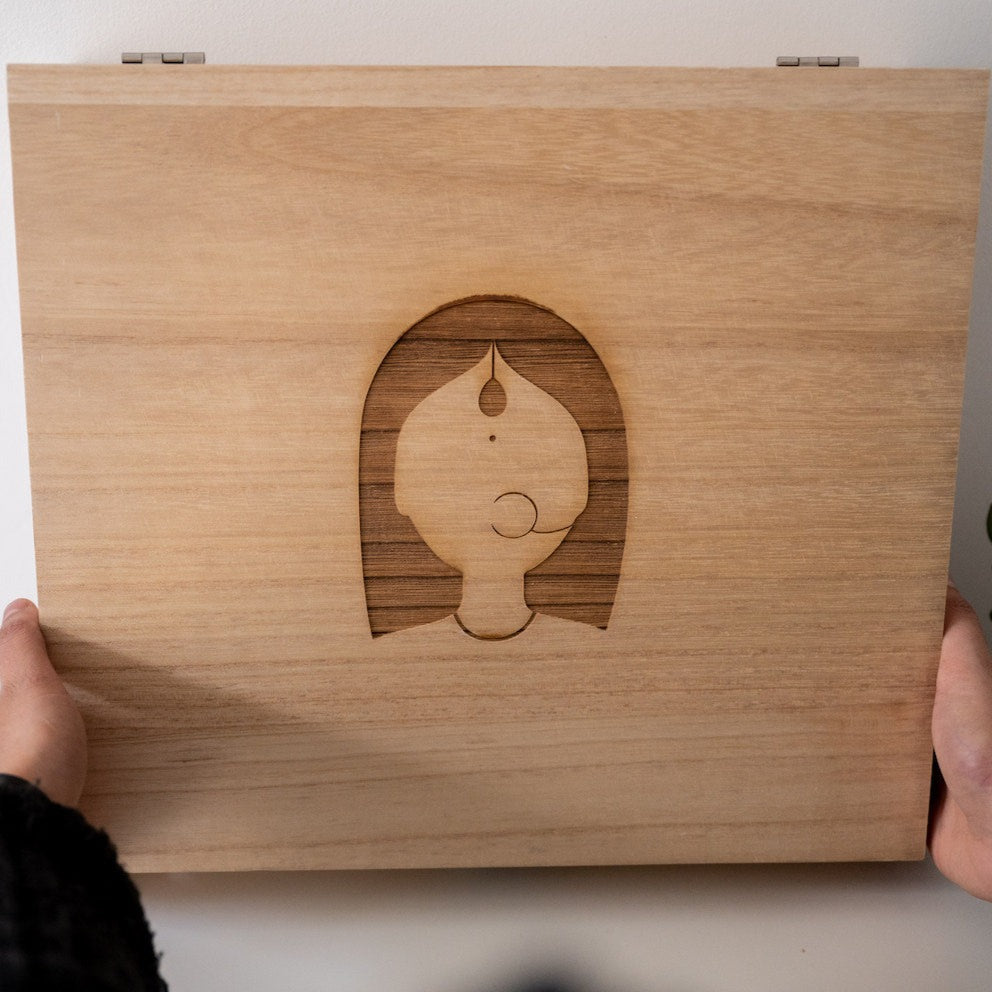 Wooden box with woman logo