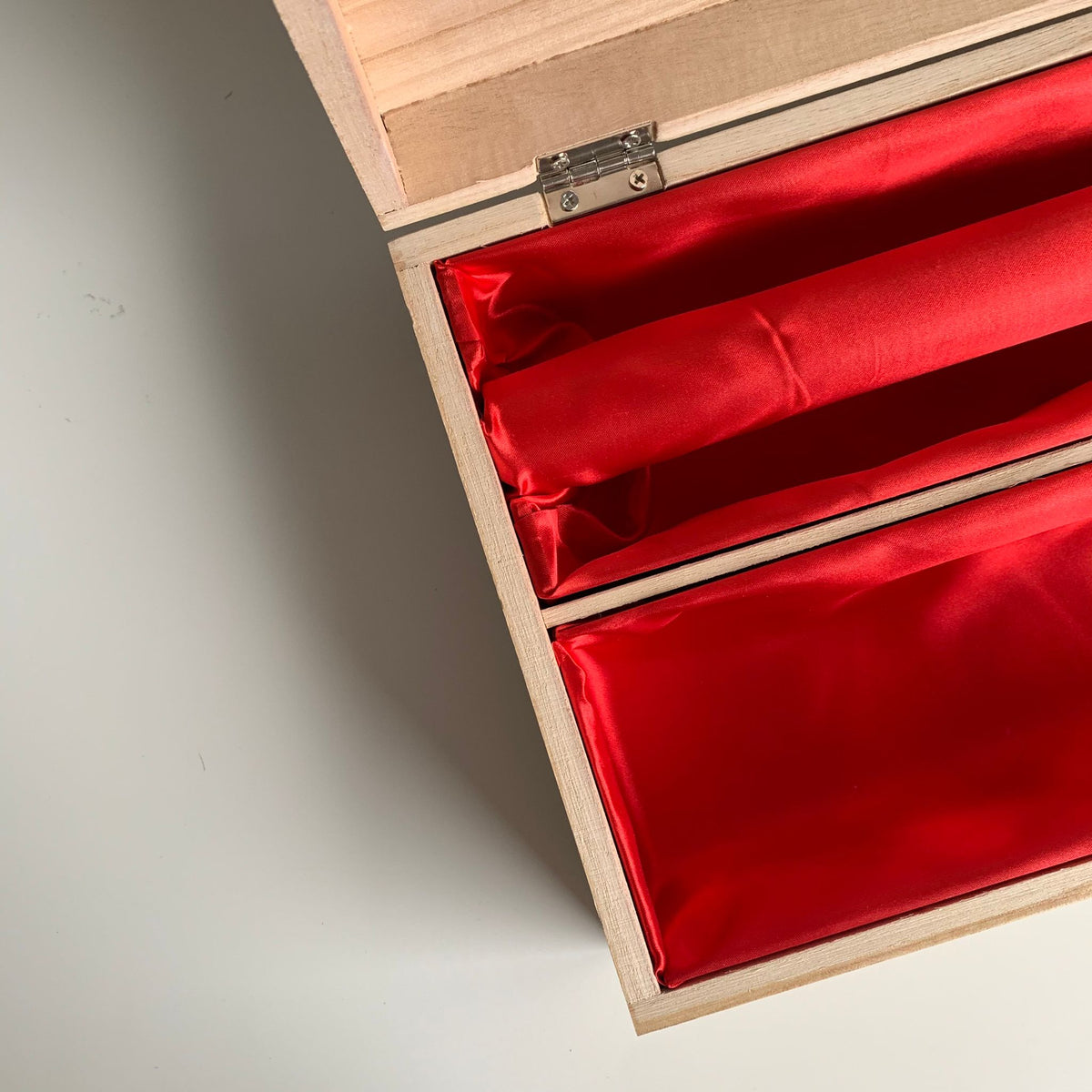 Open wooden bridal box with bangle bar and red lining