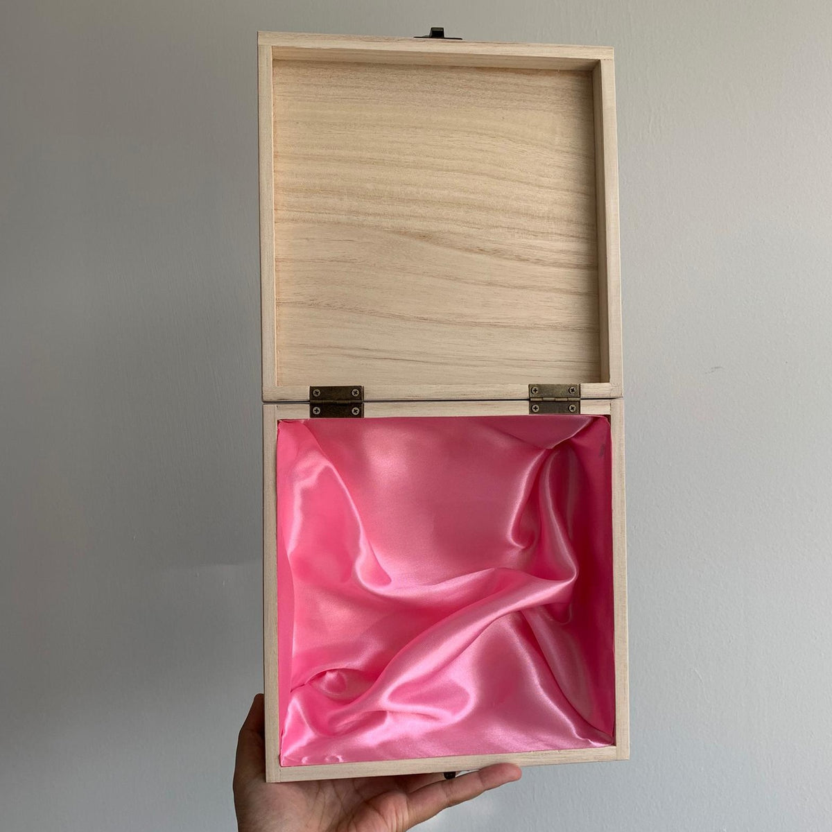 Open baby square box with pink lining